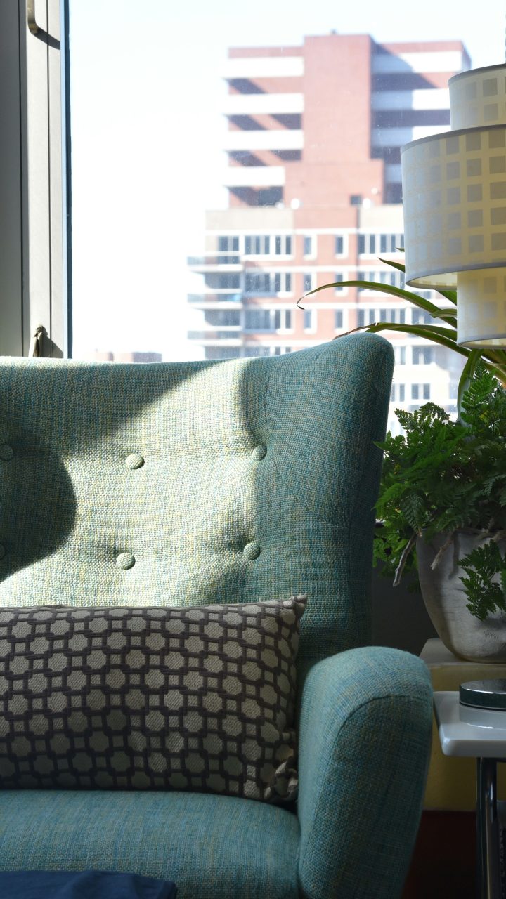 grey and white throw pillow on grey sofa chair