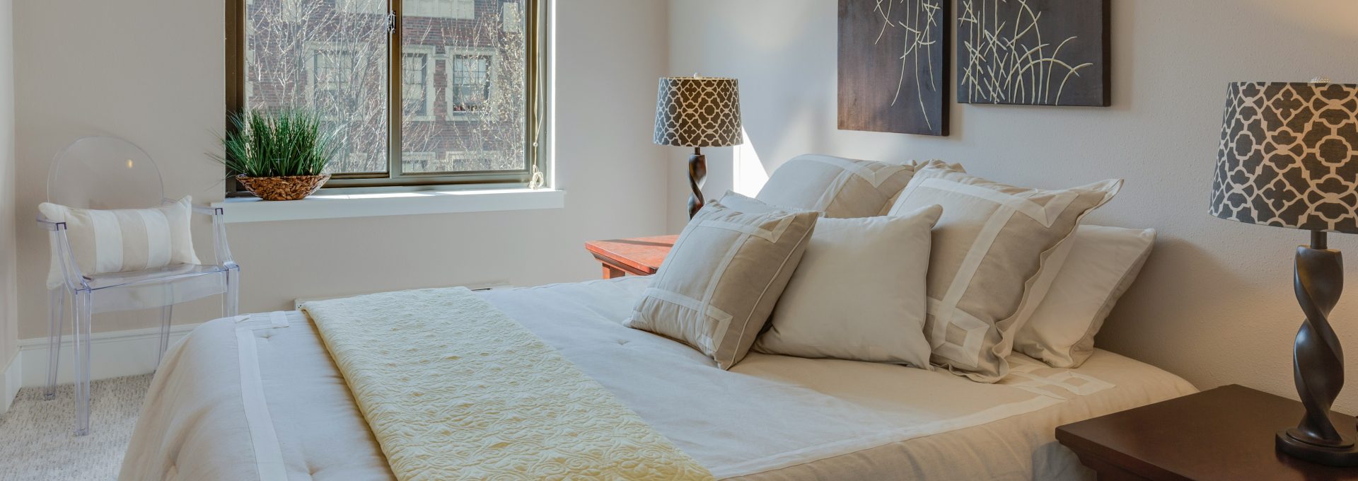 bed with comforter set beside table lamps on nightstands